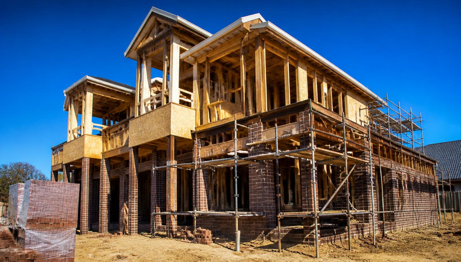 Custom home under construction with timber framing and brick veneer in Charlotte NC
